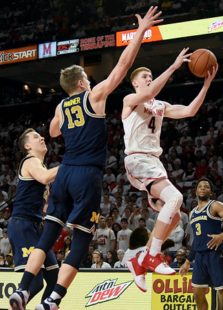 Duncan Robinson (22), Moritz Wagner (13), and Zavier Simpson (3)