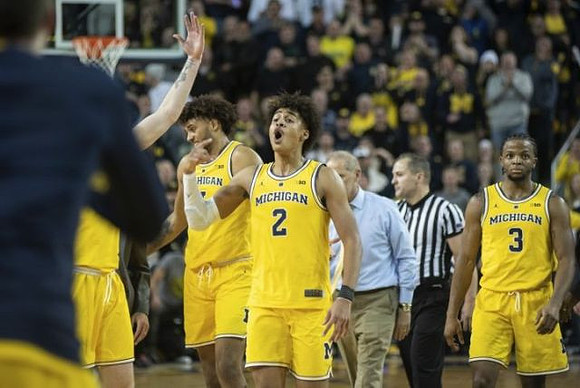 Isaiah Livers (4), Jordan Poole (2), John Beilein, and Zavier Simpson (3)
