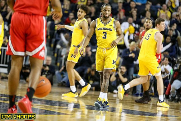 Jordan Poole (2), Zavier Simpson (3), and Jon Teske (15)