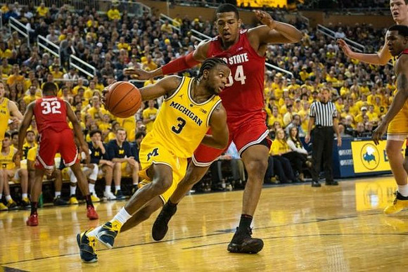 Zavier Simpson (3) and Jon Teske (15)