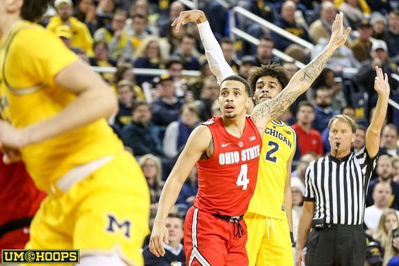 Jordan Poole (2) and Brandon Johns Jr. (23)