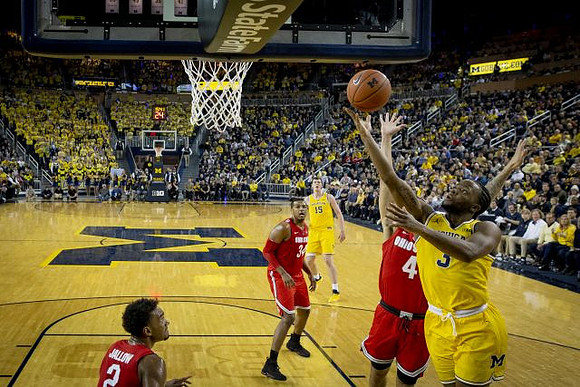 Zavier Simpson (3) and Jon Teske (15)