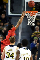 Mark Donnal (34) and Derrick Walton Jr. (10)