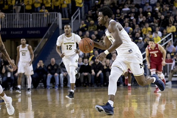 Zak Irvin (21), Muhammad-Ali Abdur-Rahkman (12), and Derrick Walton Jr. (10)