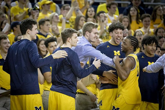 Zavier Simpson (3) and Michigan Team