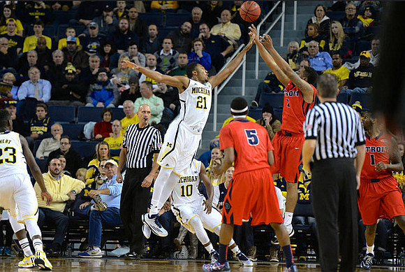 Caris LeVert (23), Zak Irvin (21), and Derrick Walton Jr. (10)