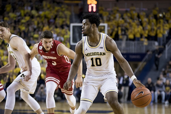 Mark Donnal (34) and Derrick Walton Jr. (10)