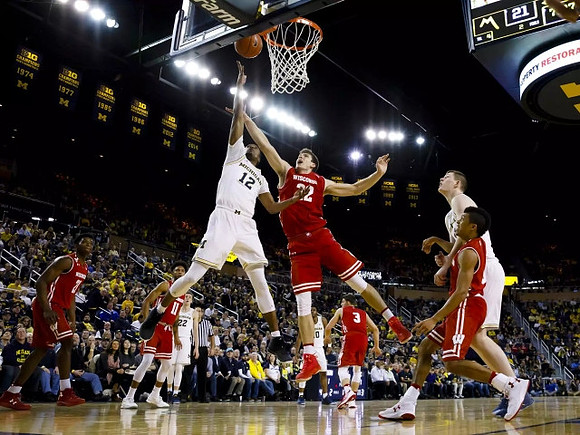 Muhammad-Ali Abdur-Rahkman (12), Jon Teske (15), Derrick Walton Jr. (10), and Duncan Robinson (22)