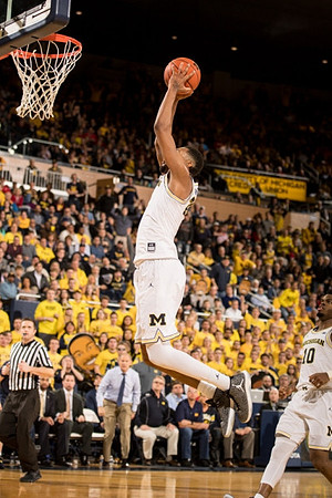 Zak Irvin (21) and Derrick Walton Jr. (10)