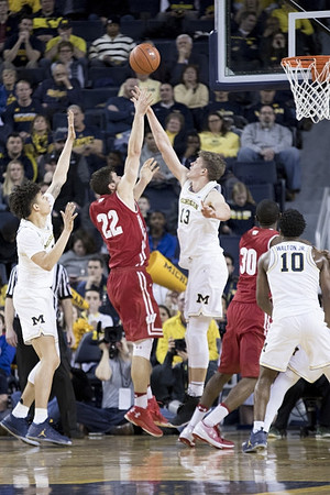 D.J. Wilson (5), Moritz Wagner (13), and Derrick Walton Jr. (10)