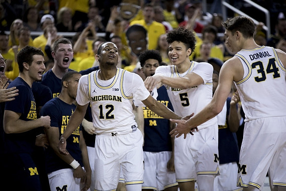 Muhammad-Ali Abdur-Rahkman (12) and Michigan Team