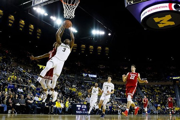 Xavier Simpson (3), Zak Irvin (21), and D.J. Wilson (5)