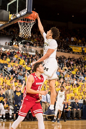 D.J. Wilson (5) and Derrick Walton Jr. (10)