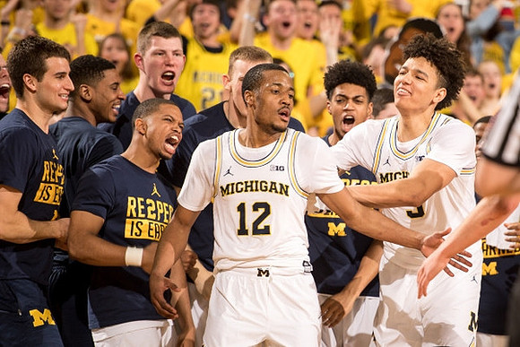 Muhammad-Ali Abdur-Rahkman (12) and Michigan Team