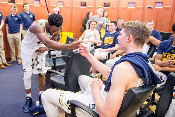 Derrick Walton Jr. (10), Moritz Wagner (13), and Michigan Team
