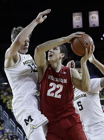 Moritz Wagner (13) and D.J. Wilson (5)