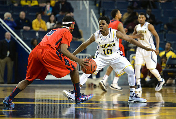 Derrick Walton Jr. (10) and Zak Irvin (21)