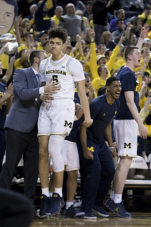 D.J. Wilson (5) and Michigan Team