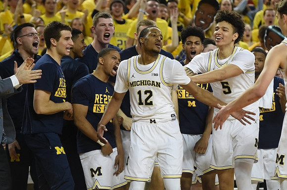 Muhammad-Ali Abdur-Rahkman (12) and Michigan Team