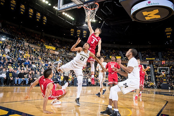 Zak Irvin (21), D.J. Wilson (5), and Muhammad-Ali Abdur-Rahkman (12)
