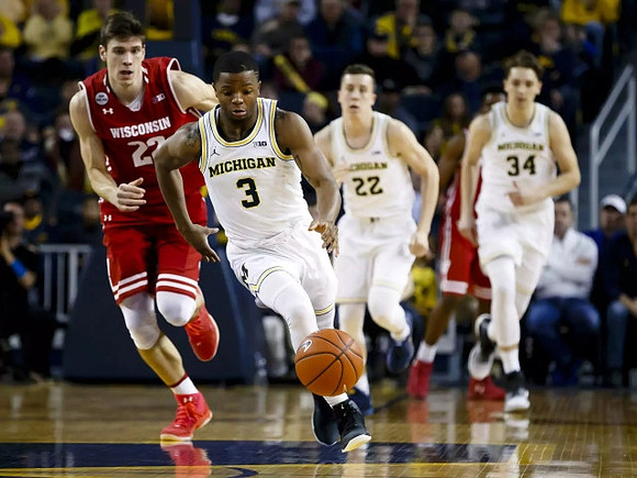 Xavier Simpson (3), Duncan Robinson (22), and Mark Donnal (34)