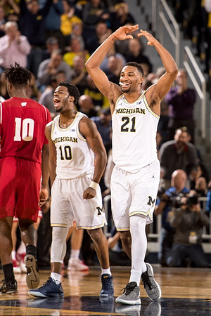 Derrick Walton Jr. (10) and Zak Irvin (21)