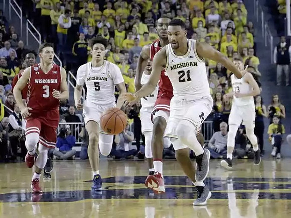 D.J. Wilson (5), Zak Irvin (21), and Moritz Wagner (13)