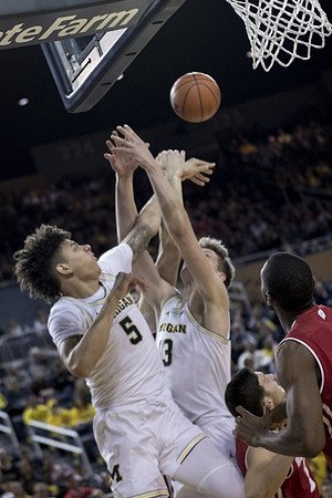 D.J. Wilson (5) and Moritz Wagner (13)
