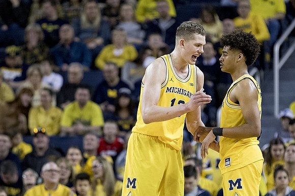 Moritz Wagner (13) and Jordan Poole (2)