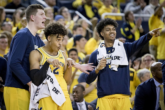 Jon Teske (15), Jordan Poole (2), and Ibi Watson (23)