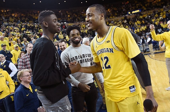 Muhammad-Ali Abdur-Rahkman (12) and Former Michigan Players Caris LeVert and Derrick Walton Jr.