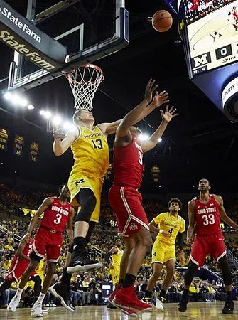 Moritz Wagner (13), Isaiah Livers (4), and Zavier Simpson (3)