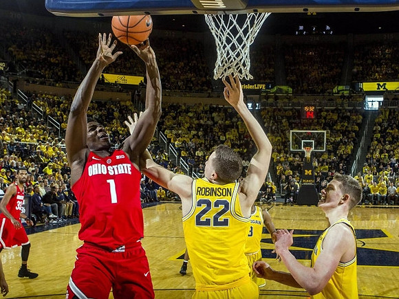Duncan Robinson (22), Moritz Wagner (13), and Zavier Simpson (3)