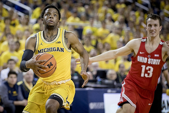 Zavier Simpson (3) and Former Michigan Player Andrew Dakich (13)