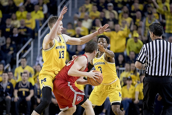 Moritz Wagner (13) and Zavier Simpson (3)