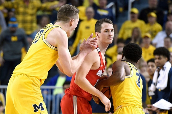 Moritz Wagner (13), Zavier Simpson (3), and Former Michigan Player Andrew Dakich (13)