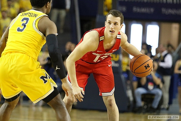 Zavier Simpson (3) and Former Michigan Player Andrew Dakich (13)