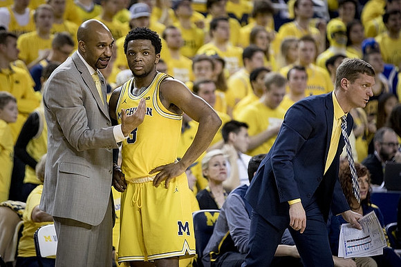 Saddi Washington, Zavier Simpson (3), and Luke Yaklich
