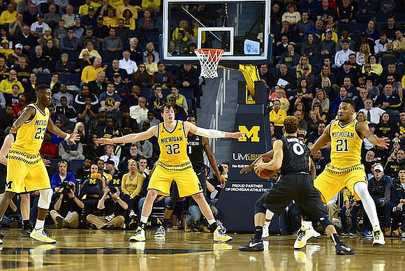 Caris LeVert (23), Ricky Doyle (32), and Zak Irvin (21)