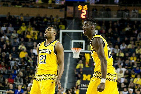 Zak Irvin (21) and Caris LeVert (23)