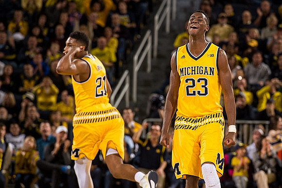 Zak Irvin (21) and Caris LeVert (23)