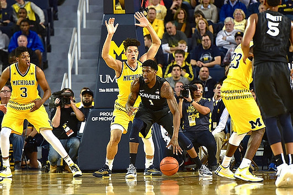 Kameron Chatman (3), D.J. Wilson (5), and Caris LeVert (23)