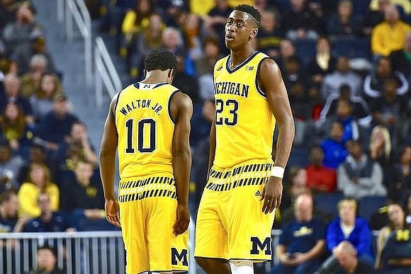 Derrick Walton Jr. (10) and Caris LeVert (23)