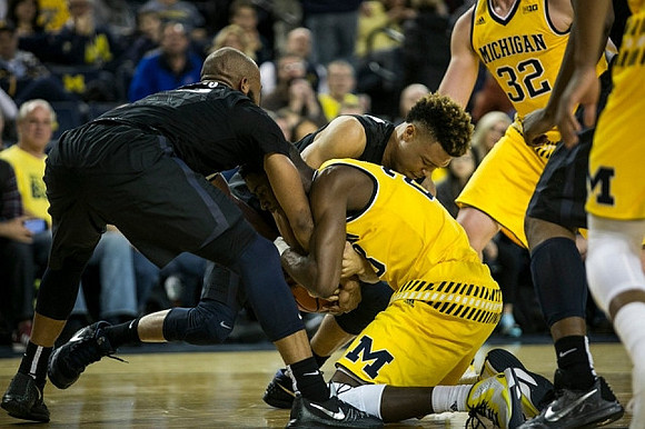 Caris LeVert (23) and Ricky Doyle (32)