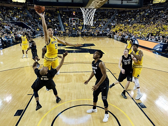 Caris LeVert (23), D.J. Wilson (5), Derrick Walton Jr. (10), and Aubrey Dawkins (24)