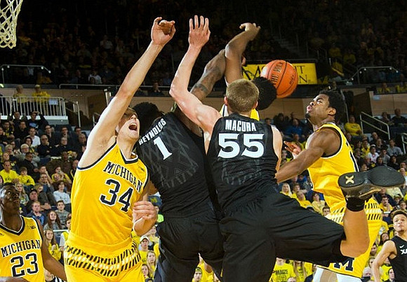 Caris LeVert (23), Mark Donnal (34), and Derrick Walton Jr. (10)