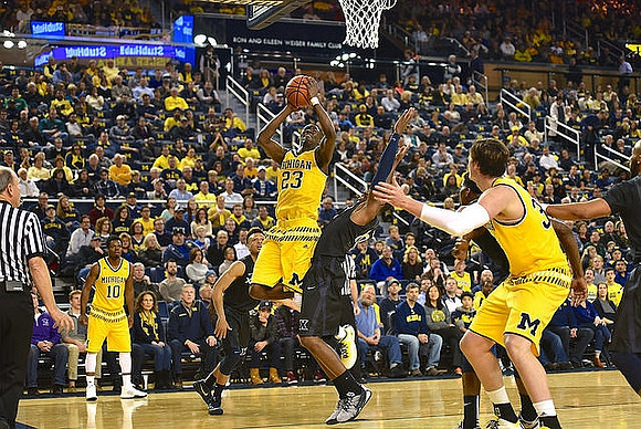 Derrick Walton Jr. (10), Caris LeVert (23), and Ricky Doyle (32)