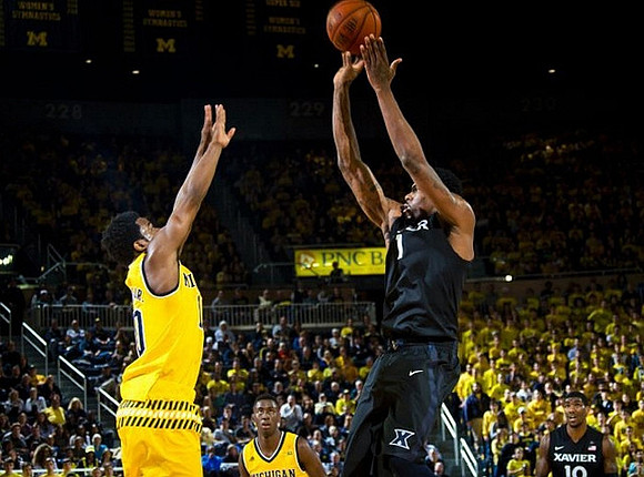 Derrick Walton Jr. (10) and Caris LeVert (23)