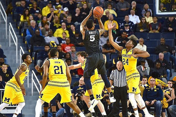 Derrick Walton Jr. (10), Zak Irvin (21), Ricky Doyle (32), and Aubrey Dawkins (24)