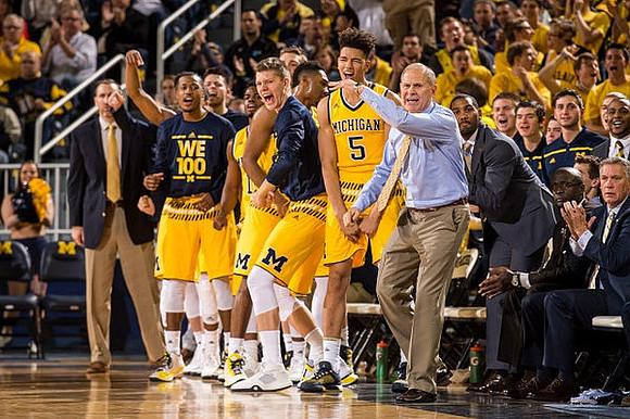Muhammad-Ali Abdur-Rahkman (12), Derrick Walton Jr. (10), Moritz Wagner (13), D.J. Wilson (5), John Beilein, LaVall Jordan, and Jeff Meyer